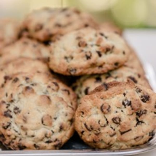 A close-up of a pile of freshly baked chocolate chip cookies from Alexandria Pastry Shop.